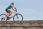 Woman Cycling On Seawall