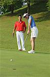 Young Couple Golfing