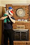 Father Holding Son on Shoulders in Man Cave