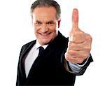 Successful entrepreneur showing thumbs-up isolated on white