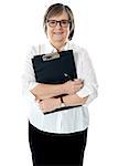 Portrait of senior businesswoman holding reports. Copy space