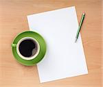 Blank paper with pen and coffee cup on wood table