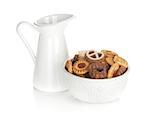 Various cookies in bowl and milk jug. Isolated on white  background