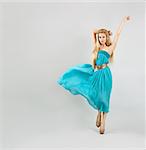 Full Length Portrait of a Sexy Blonde Woman in Turquoise Fashion Dress
