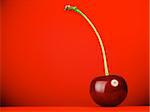 fresh red cherry with stem on red background