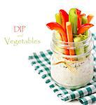Fresh vegetables with spicy yogurt dip in a glass jar.