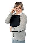 Corporate woman looking at you from within her eyeglasses. Carrying important papers