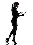 one business woman walking computer computing typing digital tablet  silhouette studio isolated on white background