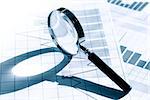 Business concept. Magnifying glass on paper background with chart