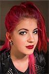 Attractive Caucasian female with pink hair grinning