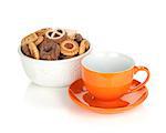 Various cookies in bowl and orange tea cup. Isolated on white background