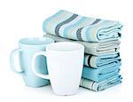 Kitchen towels and tea cups. Isolated on white background