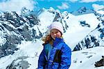 Summer mountain view from Stelvio pass with snow on slope (Italy) and girl portrait.