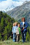 Family (mother with children) walk on summer Alps mountain (Switzerland, Zermatt, Matterhorn mount view)