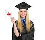 Happy young woman in graduation gown showing diploma