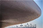 Overhanging roof of the London 2012 aquatic centre, by Zaha Hadid, with the olympic stadium in the background, Stratford, London, UK