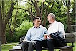 Businessmen Talking on Park Bench, Mannheim, Baden-Wurttemberg, Germany