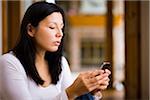 Woman sending a text message on a smart phone.