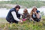 Parents and son picking bilberries