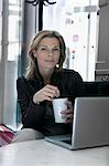 Businesswoman sitting in office with mug
