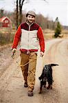 Smiling man walking dog