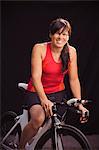 Studio shot of smiling woman with bicycle