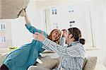 A Couple Pillow Fights In Their Living Room