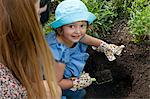 Mother and daughter planting together in the garden, Munich, Bavaria, Germany