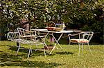 Garden table and chairs next to apple tree, Munich, Bavaria, Germany