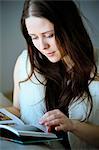 Woman with brown hair reading a book, Copenhagen, Denmark