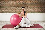 Woman Sitting On Exercise Mat, Munich, Bavaria, Germany, Europe