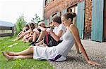 Teenagers Relaxing In Front Of A House, Sonthofen, Schattwald, Bavaria, Germany