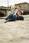 Young couple having a cup of coffee outdoors, Munich, Bavaria, Germany