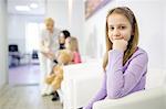 Girl in waiting room, three people in background, Osijek, Croatia
