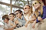 Children watching television wearing 3D glasses, Osijek, Croatia, Europe