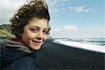 Portrait of a boy smiling on a beach, iceland