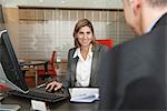 Businesswoman assisting client in office