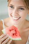 Young woman eating watermelon, portrait