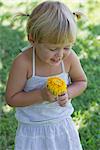 Little girl holding flower, portrait