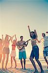 Friends dancing and having fun on the beach