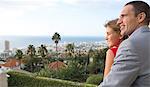 Couple looking at the view from their balcony