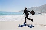 Businessman running on the beach