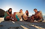 Group of friends sitting on the beach