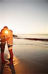 Cheerful lovers embracing each other on the beach