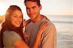 Young lovers embracing on the beach