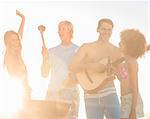 Attractive man playing guitar on the beach