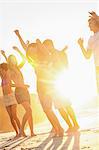 Friends dancing on the beach