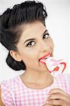 Seductive young pinup licking a lollipop