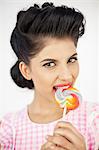 Cute young pinup biting a lollipop