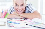 Female designer posing at her desk